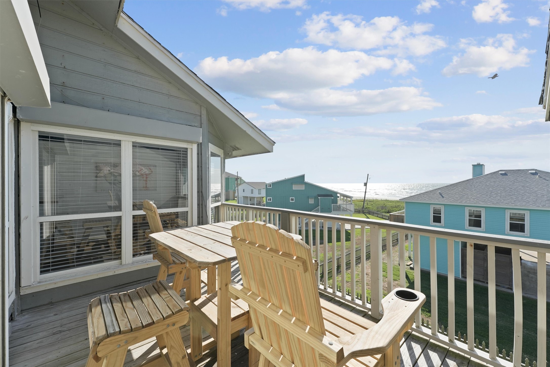 17607 Termini-San Luis Pass Road Galveston, TX 77554 - Photo 7 of 42 This cozy balcony offers seating with a view of the surrounding community and the Gulf beyond. The open design allows you to relax and soak in the fresh ocean air.