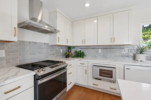 a kitchen with cabinets stainless steel appliances and a counter space