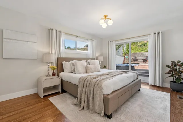 a spacious bedroom with a bed and a chandelier