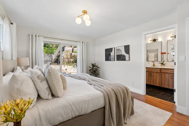 a bedroom with a bed and a chandelier