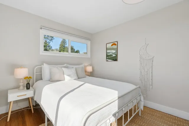 a bedroom with a bed and a painting on the wall