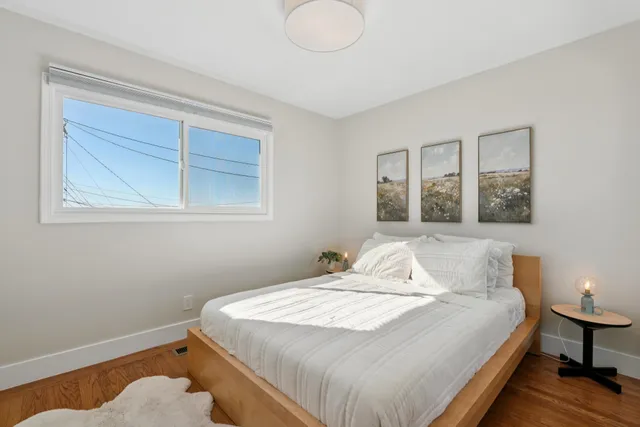 a bedroom with a bed and a lamp on table