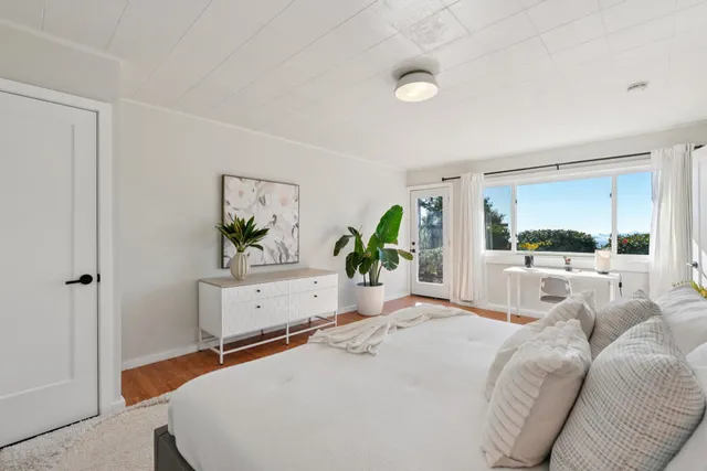 a bedroom with a large bed and a window