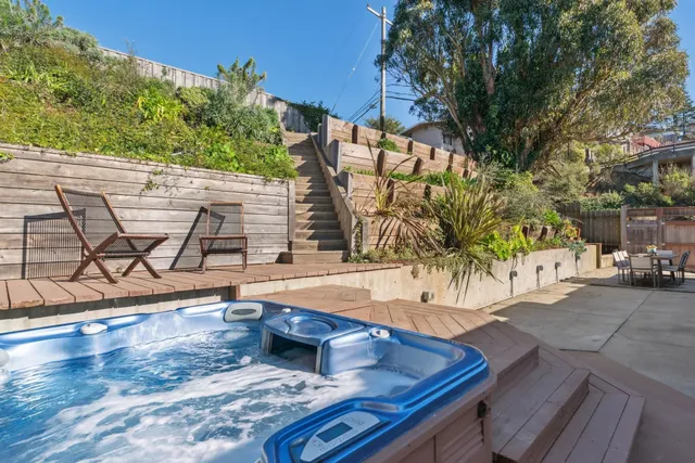 a view of a swimming pool with a patio and plants