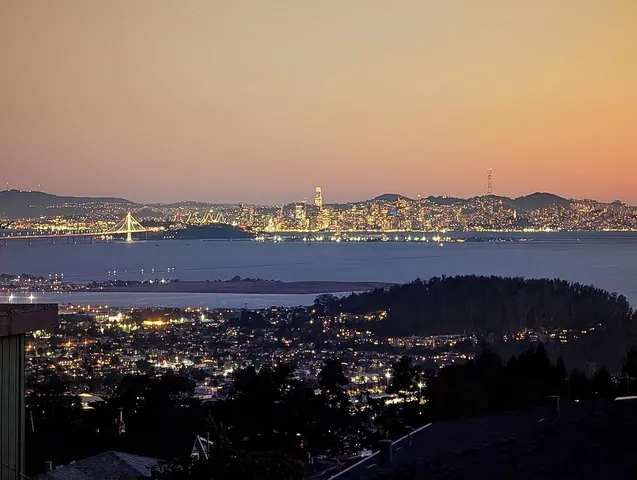 a view of a balcony with two chairs and a potted plant