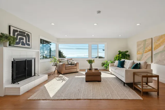 a living room with furniture fireplace and window