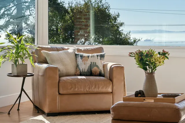 a table with a couch and a potted plant
