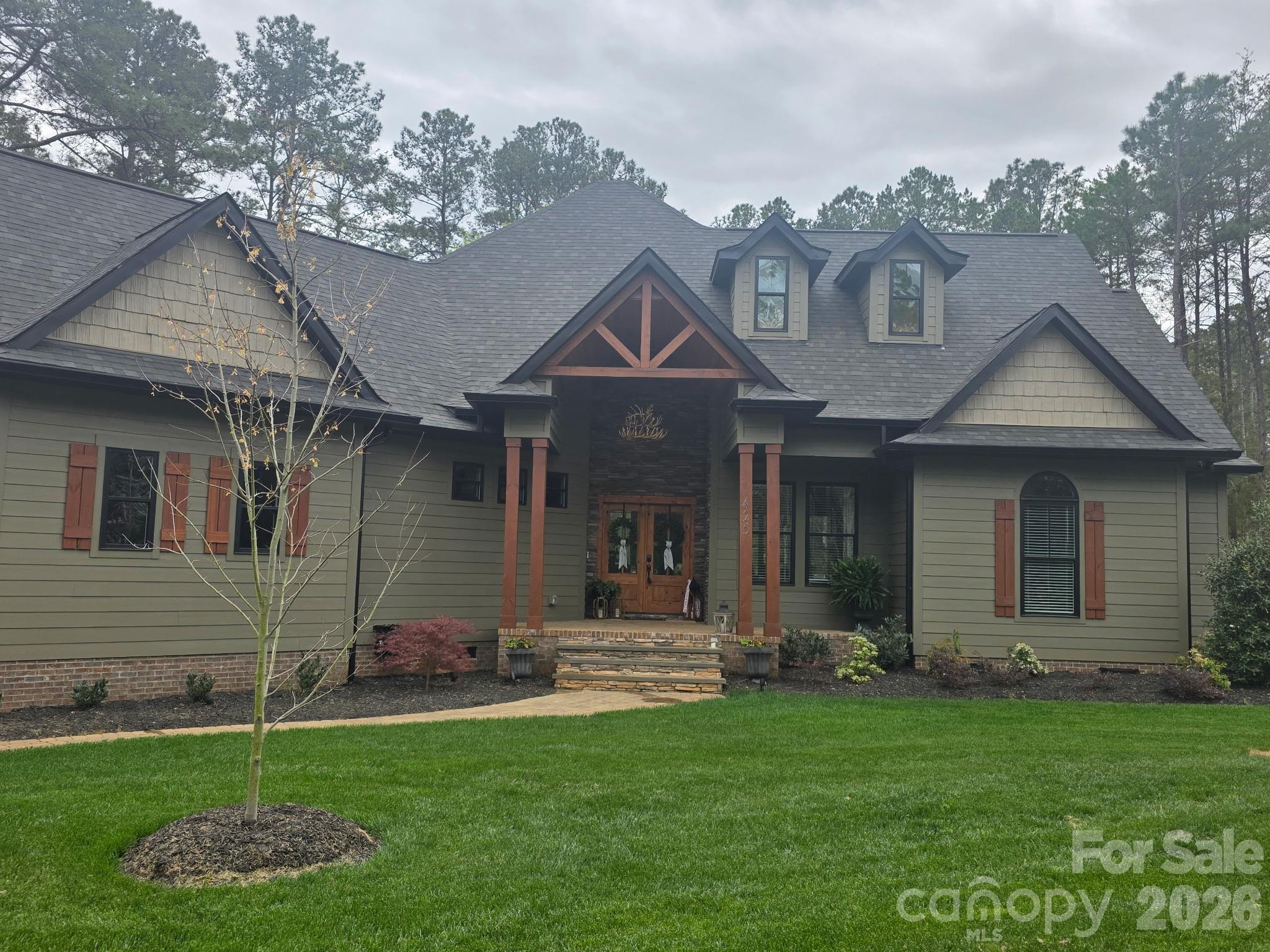 a front view of a house with a yard