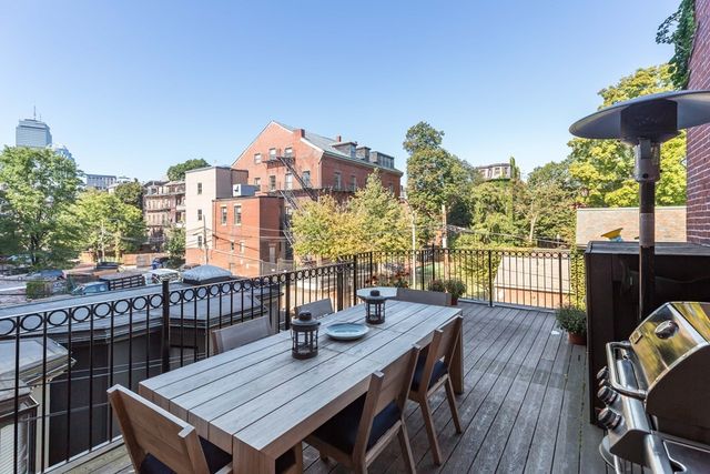 a view of a roof deck with furniture