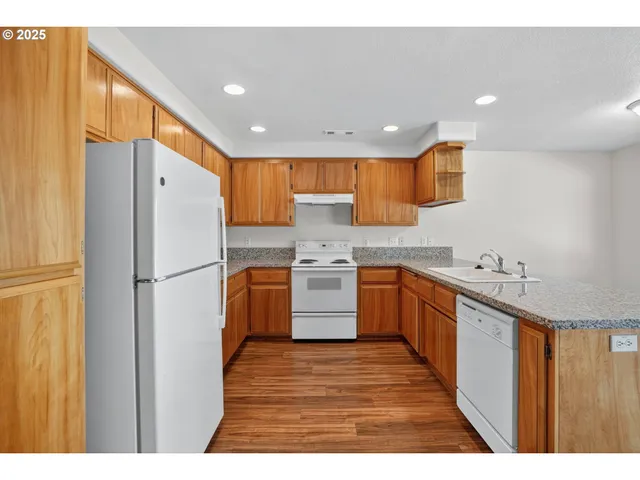 a kitchen with stainless steel appliances a refrigerator sink and cabinets