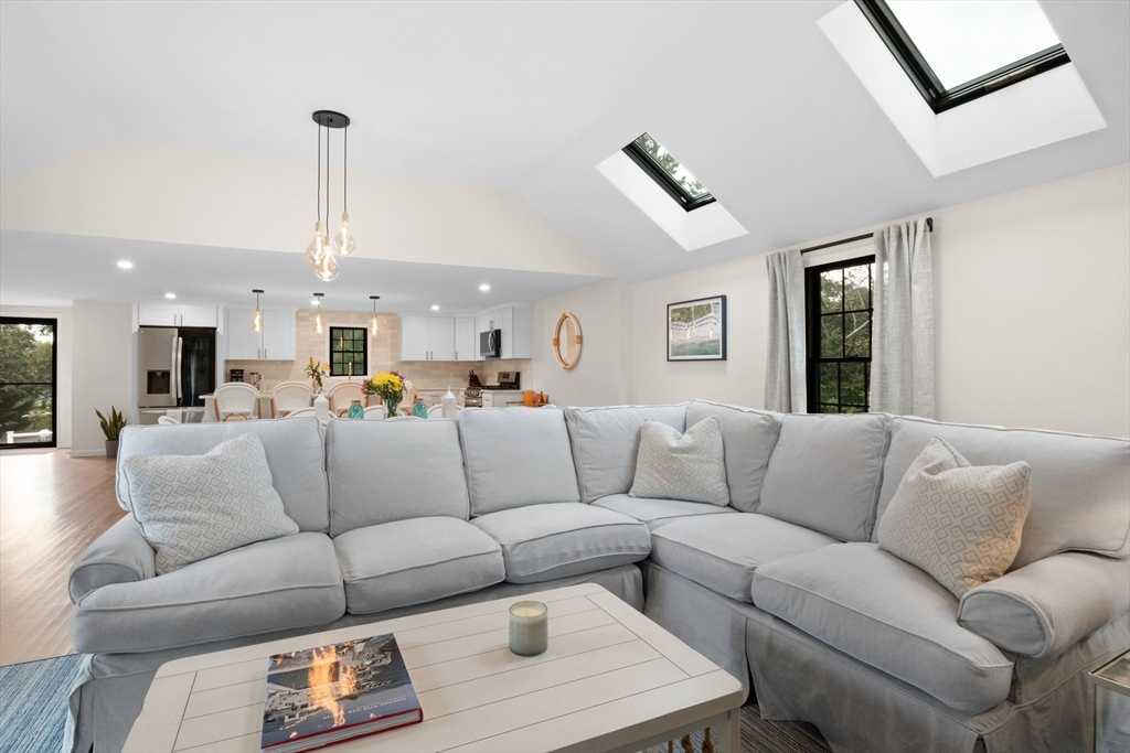 101 Monomoyic Way Chatham, MA 02633 - Photo 4 of 18 a living room with furniture kitchen view and a chandelier