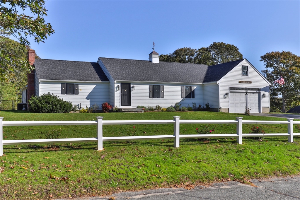 101 Monomoyic Way Chatham, MA 02633 - Photo 6 of 18 a front view of a house with a garden