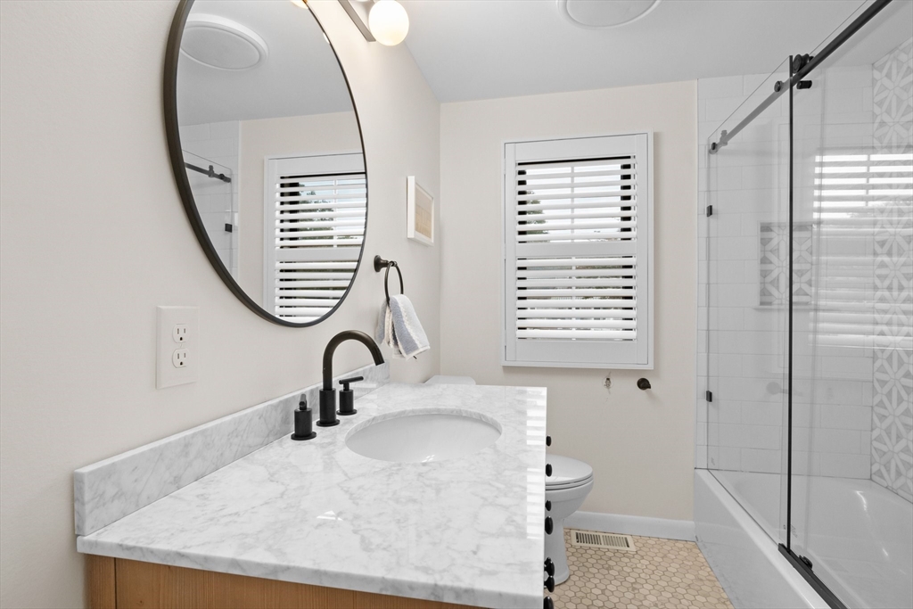 101 Monomoyic Way Chatham, MA 02633 - Photo 10 of 18 a bathroom with a sink a toilet and a mirror