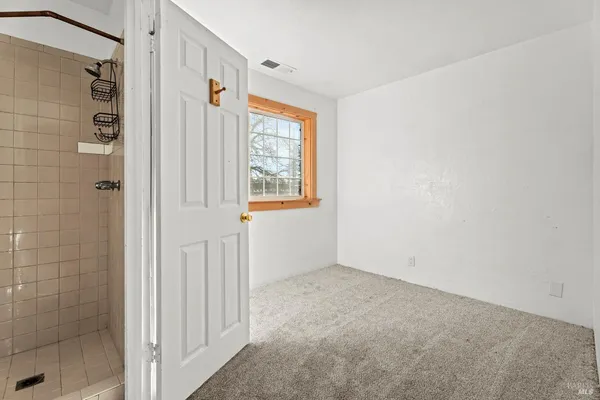 a bathroom view of a toilet and a shower