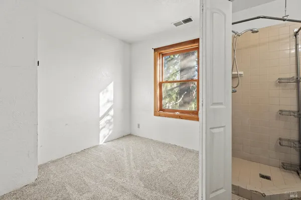 a view of an empty room and closet area