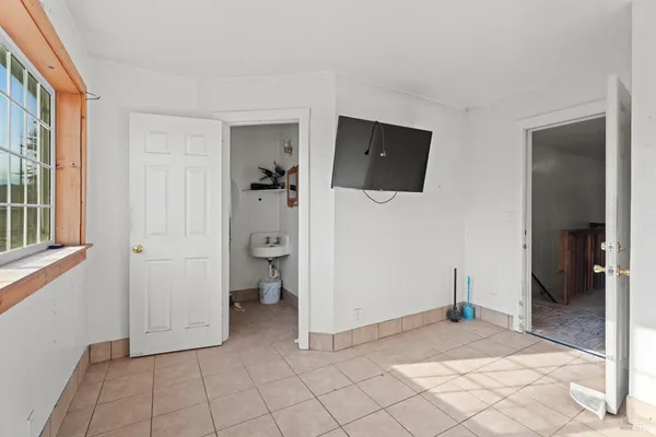 an empty room with windows and closet