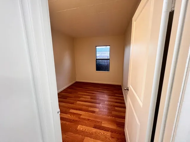 a view of an empty room and wooden floor