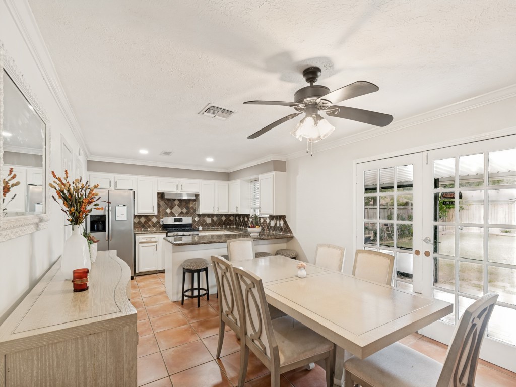 124 Bluebird Lane Pasadena, TX 77502 - Photo 5 of 25 a kitchen with a table chairs stove and cabinets