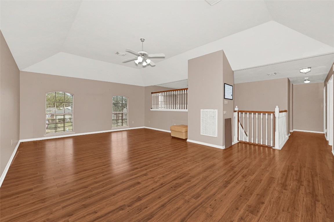 1503 Pine Ridge Lane Pearland, TX 77581 - Photo 13 of 23 a view of an empty room with wooden floor and a window