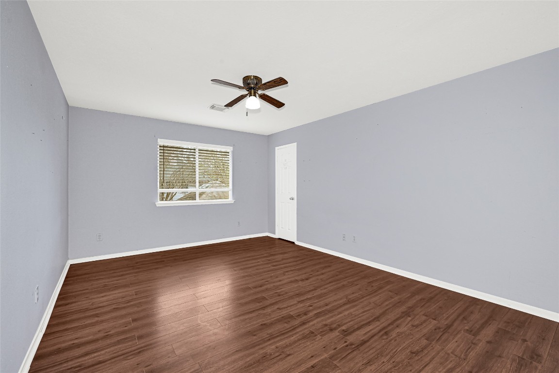 1503 Pine Ridge Lane Pearland, TX 77581 - Photo 16 of 23 a view of empty room with wooden floor and fan