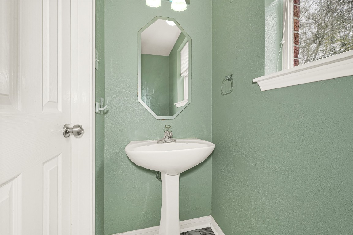 1503 Pine Ridge Lane Pearland, TX 77581 - Photo 18 of 23 a bathroom with a sink and a mirror