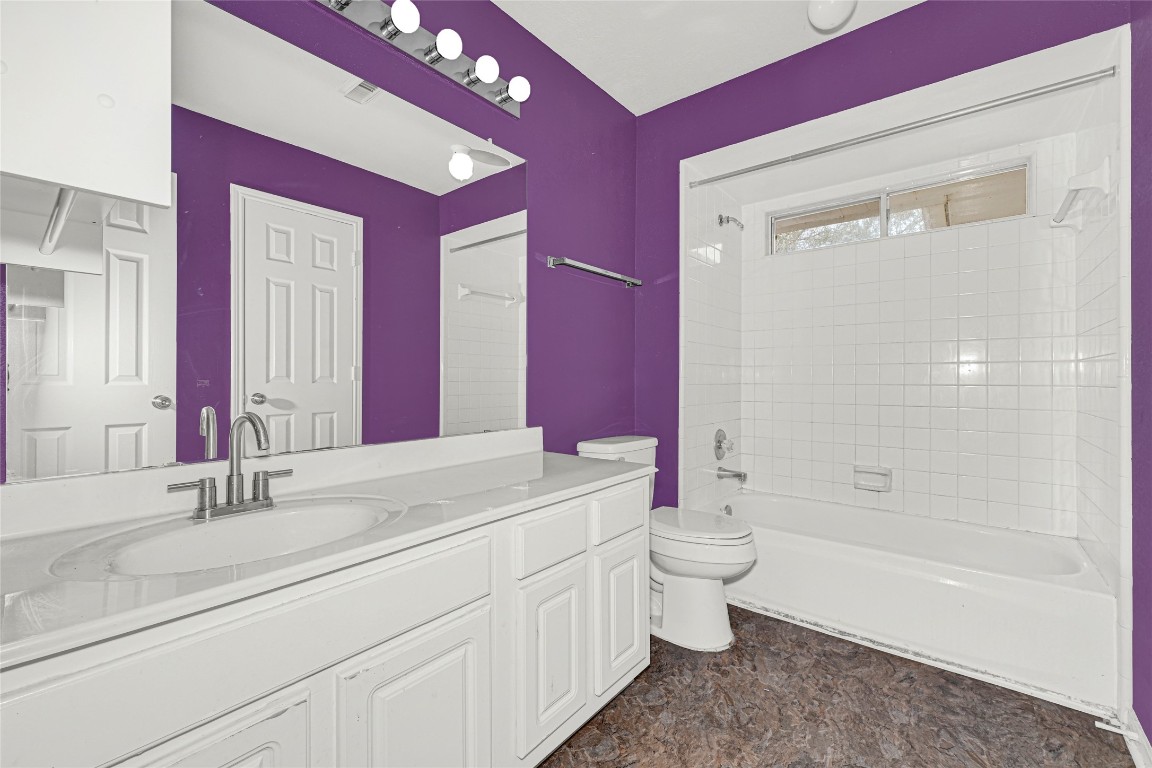 1503 Pine Ridge Lane Pearland, TX 77581 - Photo 20 of 23 a bathroom with a double vanity sink mirror and toilet