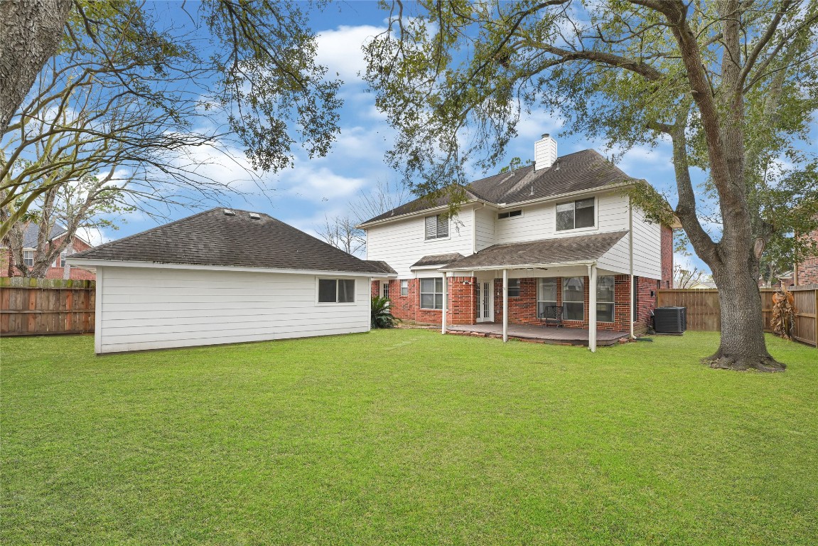 1503 Pine Ridge Lane Pearland, TX 77581 - Photo 4 of 23 a front view of a house with a yard