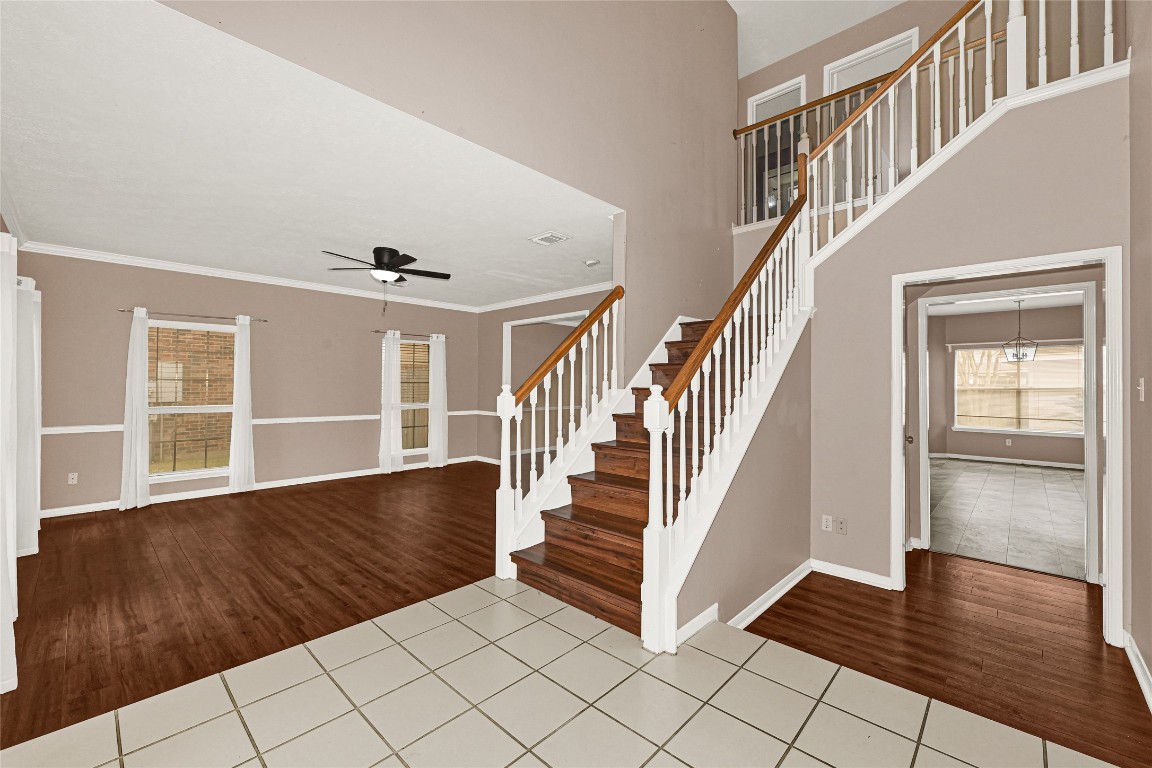 1503 Pine Ridge Lane Pearland, TX 77581 - Photo 5 of 23 a view of an entryway with wooden floor and stairs