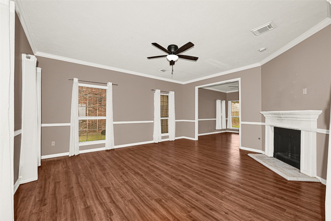1503 Pine Ridge Lane Pearland, TX 77581 - Photo 6 of 23 a view of an empty room with wooden floor fireplace and a window