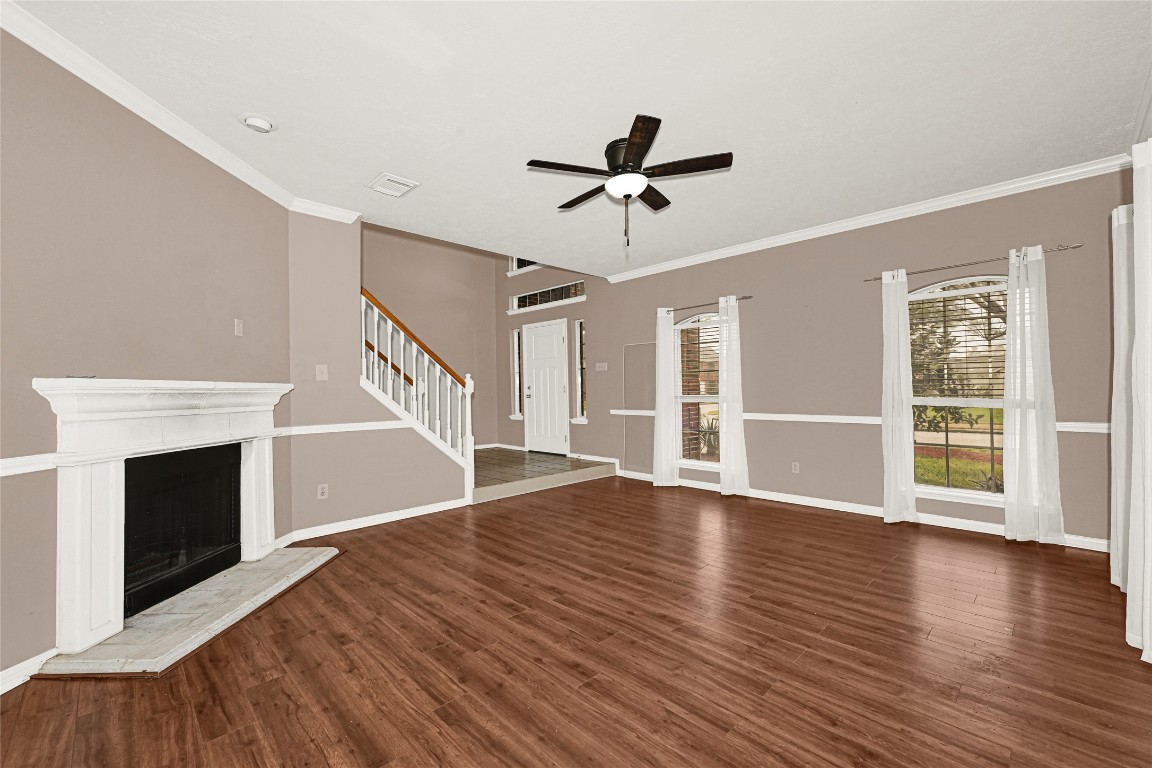 1503 Pine Ridge Lane Pearland, TX 77581 - Photo 7 of 23 a view of an empty room with wooden floor fireplace and a window