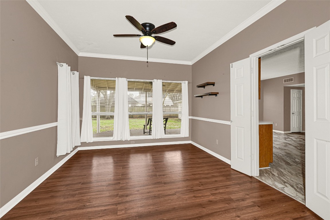 1503 Pine Ridge Lane Pearland, TX 77581 - Photo 8 of 23 a view of an empty room with wooden floor and a window