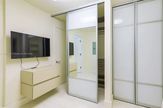 a living room with hardwood floor and flat screen tv