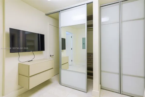 a living room with hardwood floor and flat screen tv
