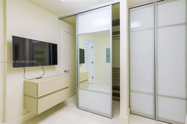 a living room with hardwood floor and flat screen tv