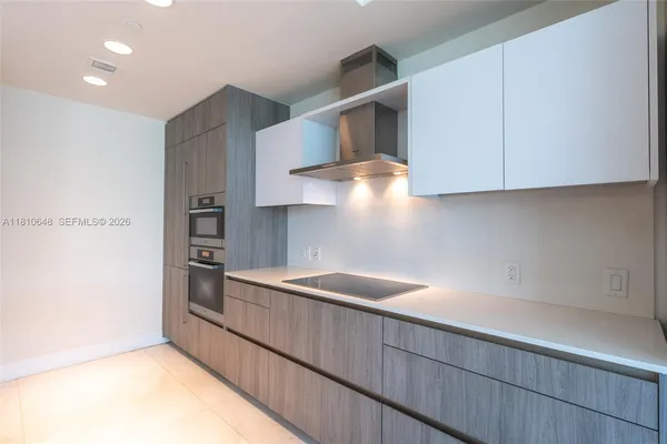 a kitchen with stainless steel appliances granite countertop a sink and a stove