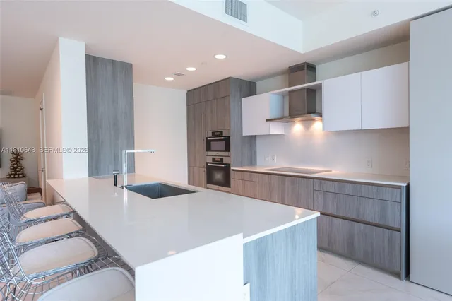 a kitchen with stainless steel appliances a sink and a refrigerator
