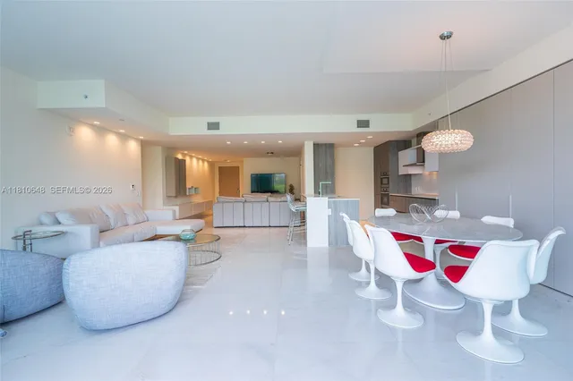 a living room with furniture and kitchen view