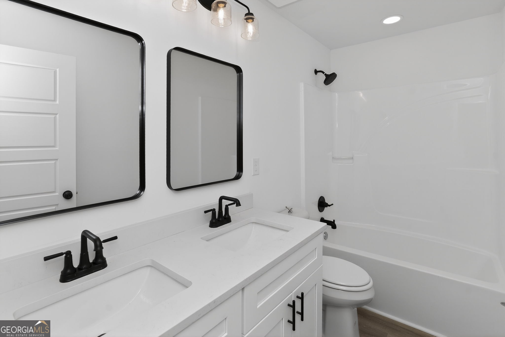 1229 Chappell Mill Road Jackson, GA 30233 - Photo 39 of 55 a bathroom with a sink a toilet and a mirror