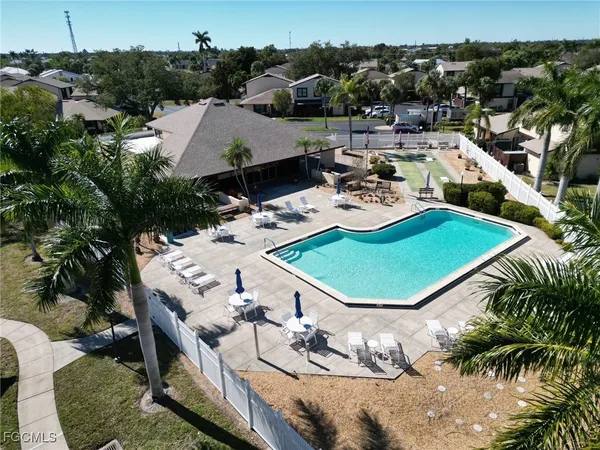 an aerial view of a house with table and chairs