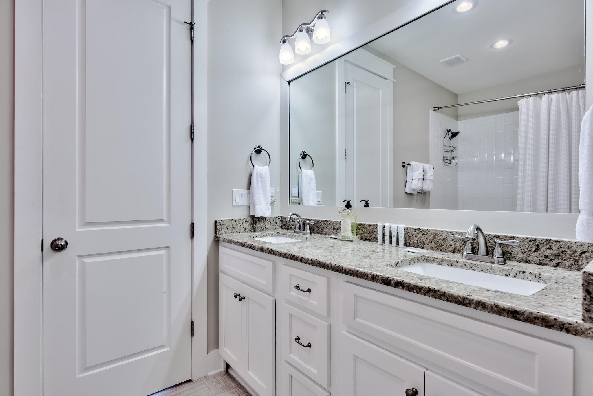 105 Blue Dolphin Loop Inlet Beach, FL 32461 - Photo 18 of 42 a bathroom with a granite countertop double vanity sink and a mirror