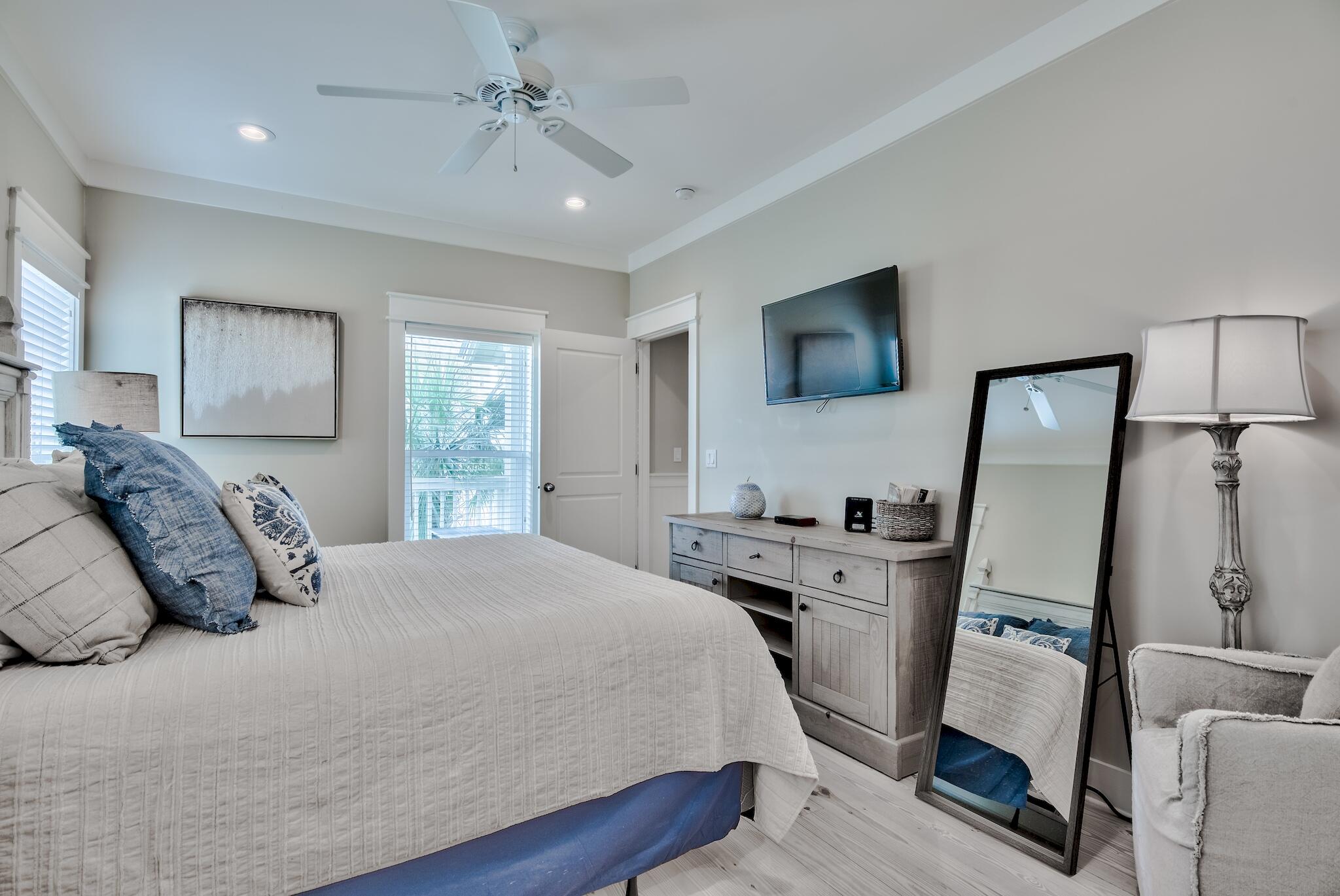 105 Blue Dolphin Loop Inlet Beach, FL 32461 - Photo 22 of 42 a bedroom with a bed a flat screen tv and a chandelier