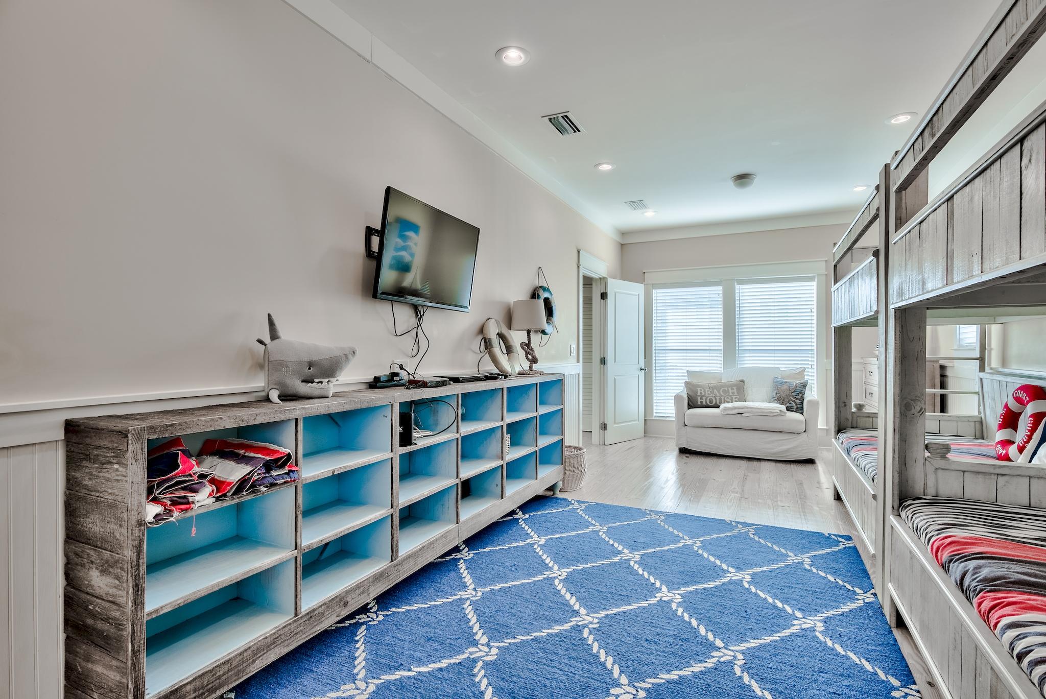 105 Blue Dolphin Loop Inlet Beach, FL 32461 - Photo 26 of 42 a living room with a couch and a flat screen tv