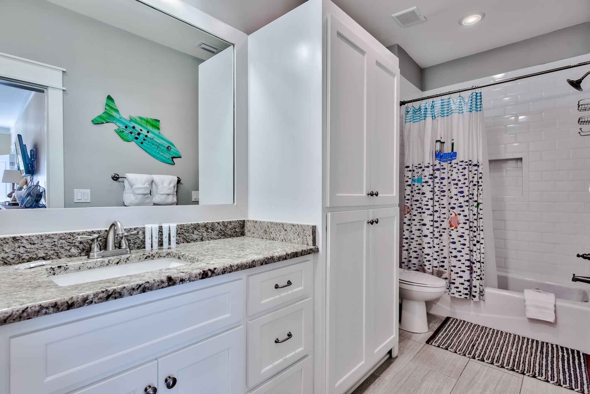 105 Blue Dolphin Loop Inlet Beach, FL 32461 - Photo 27 of 42 a bathroom with a granite countertop sink a toilet and shower