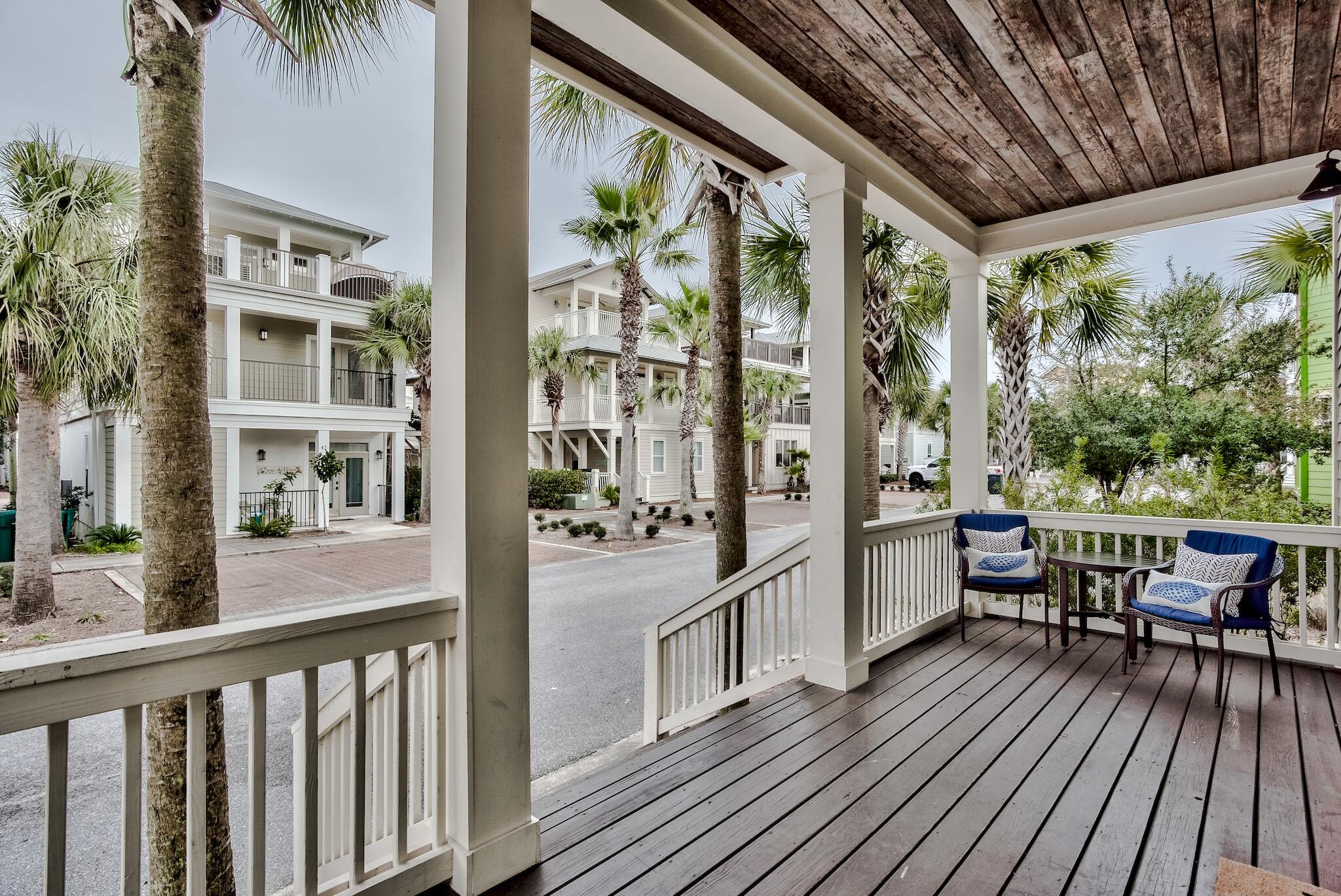 105 Blue Dolphin Loop Inlet Beach, FL 32461 - Photo 4 of 42 a view of a balcony with chairs and wooden floor