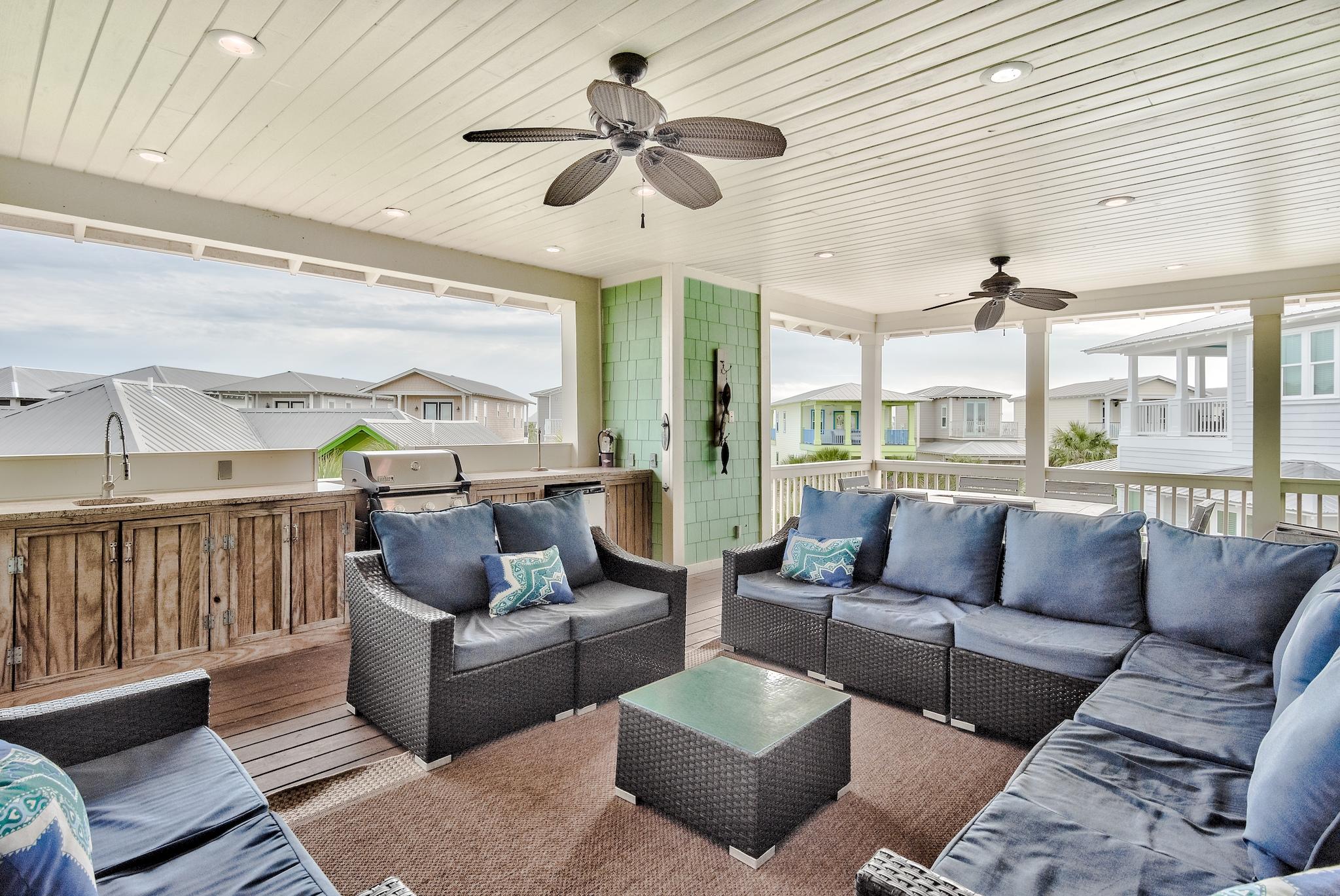 105 Blue Dolphin Loop Inlet Beach, FL 32461 - Photo 31 of 42 a living room with furniture ceiling fan and a large window