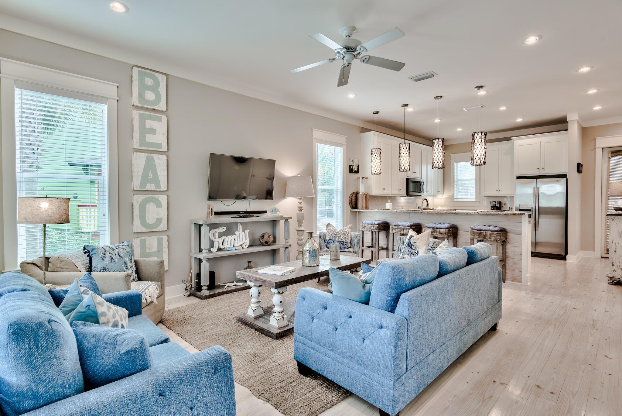 105 Blue Dolphin Loop Inlet Beach, FL 32461 - Photo 6 of 42 a living room with furniture kitchen view and a flat screen tv