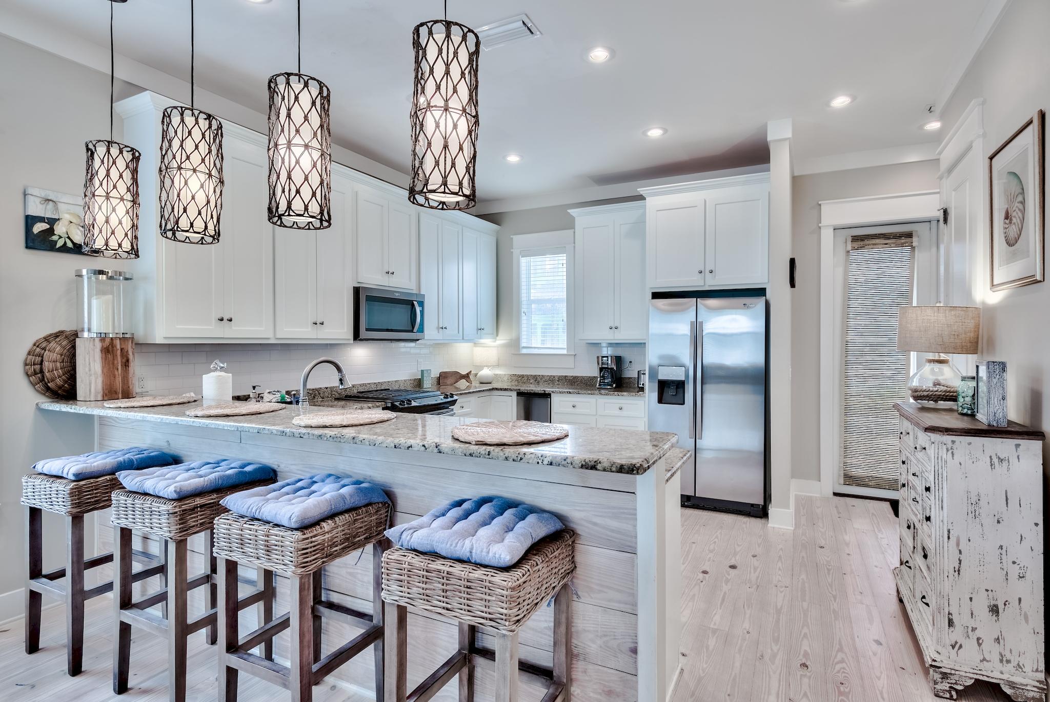 105 Blue Dolphin Loop Inlet Beach, FL 32461 - Photo 8 of 42 a kitchen with refrigerator cabinets and a table