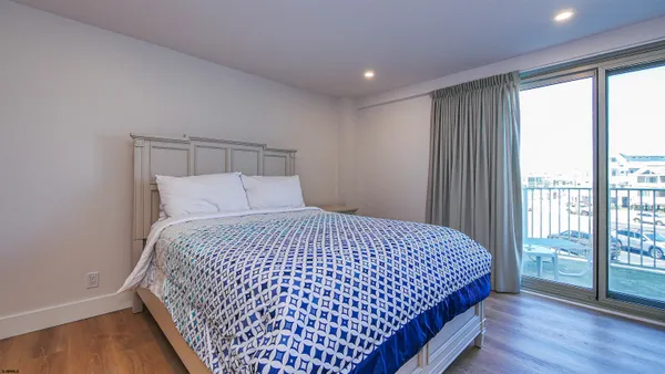 a bedroom with a large bed and a flat screen tv