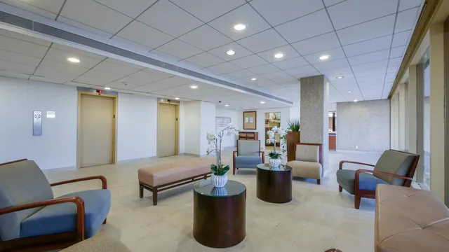 a living room with furniture and large windows