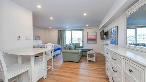 a living room with furniture and a wooden floor